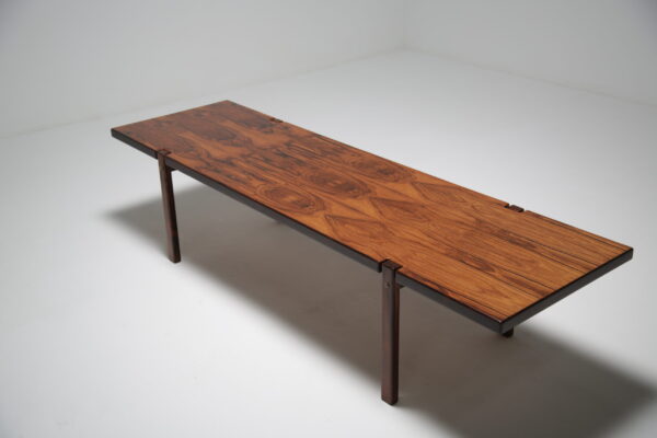 Long and narrow rosewood coffee table.