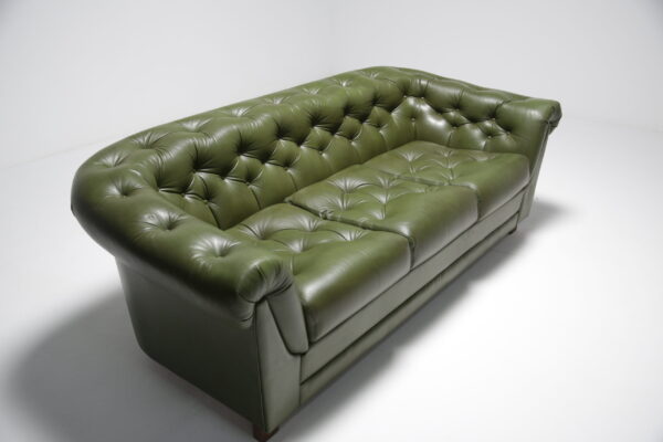 Green leather chesterfield style sofa.